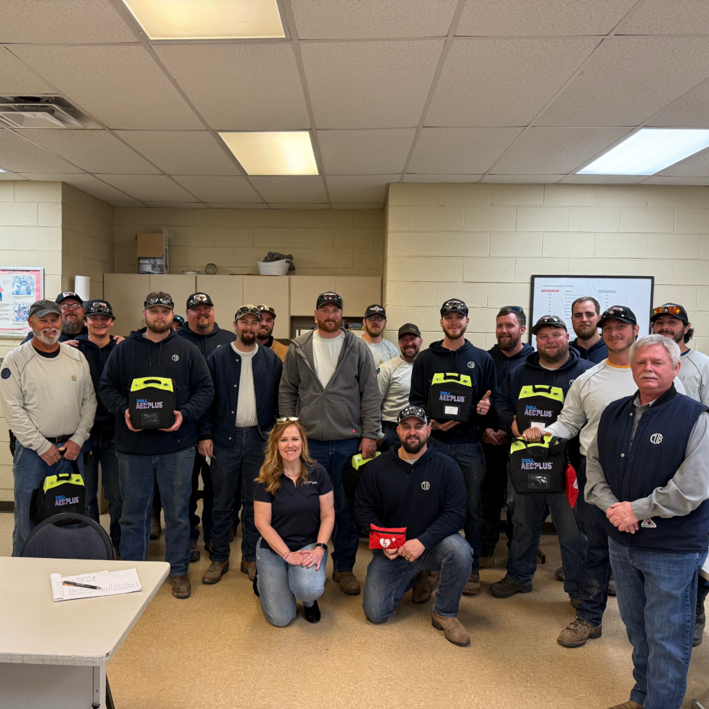Cheryl Smith with Clinton Utility Board Posing with ZOLL AEDs