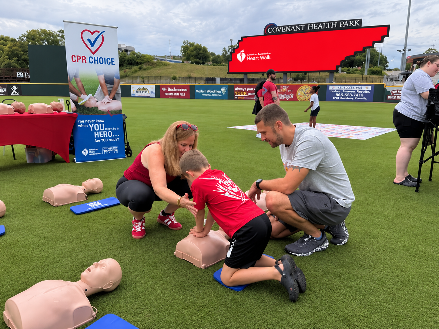 Child practicing Hands-Only CPR with CPR Choice at the 2026 Greater Knoxville Heart Walk at Covenant Health Park.